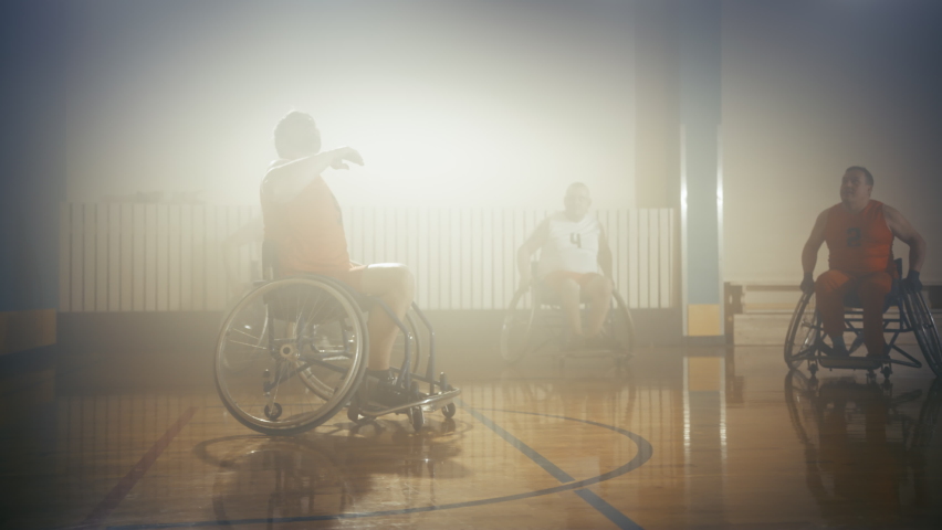 Wheelchair Basketball Game Court Winning Team Celebrate Victory, Cheer and High Five. Players Compete, Shoot, Score Goal Points. Determination, Skill of People with Disability. Handheld Dolly Shot Royalty-Free Stock Footage #1083576628