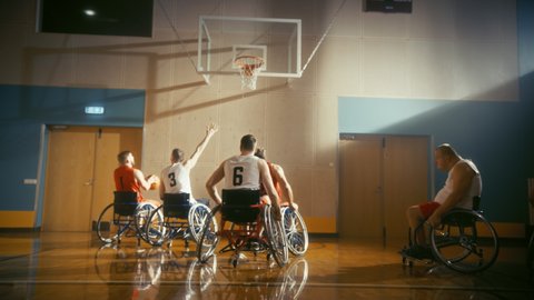 Wheelchair Basketball Game Court: Players Competing, Dribbling, Shooting it Successfully, Score Goal Points. Determination, Skill of People with Disability. Slow Motion, Handheld Following Shot