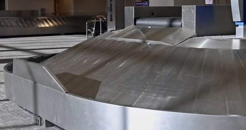 Baggage pickup carousel with on a luggage belt at the airport terminal