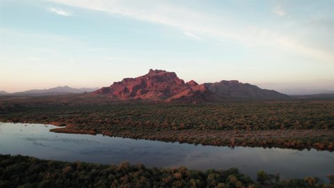 Golden Hour at Red Mountain by Phoenix Arizona with Drone Dolly Along Salt River. Aerial floating sideways along shore with Scenic nature landscape in Southwest America
