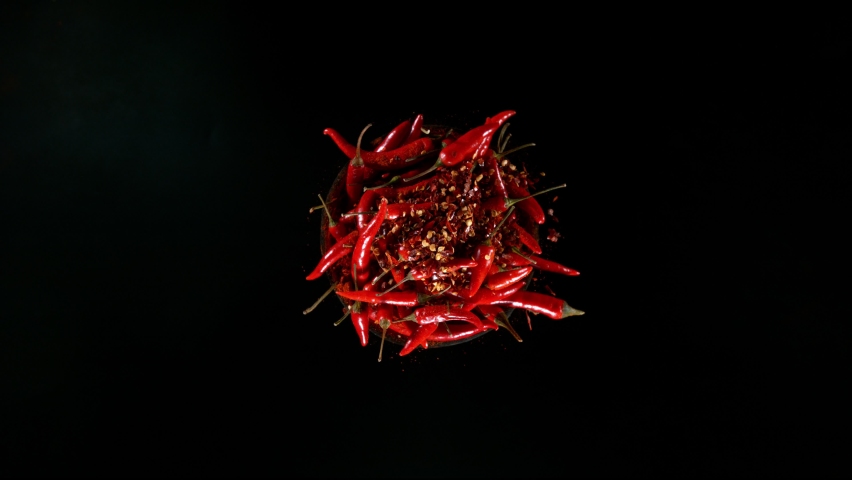 Super Slow Motion Shot of Rotating Red Chilli Peppers with Powder, Filmed on High Speed Cinematic Camera at 1000 fps. Royalty-Free Stock Footage #1083588241