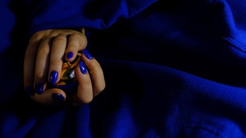 Blue nails on the womans hands girls manicure with blue color and silver sparks
