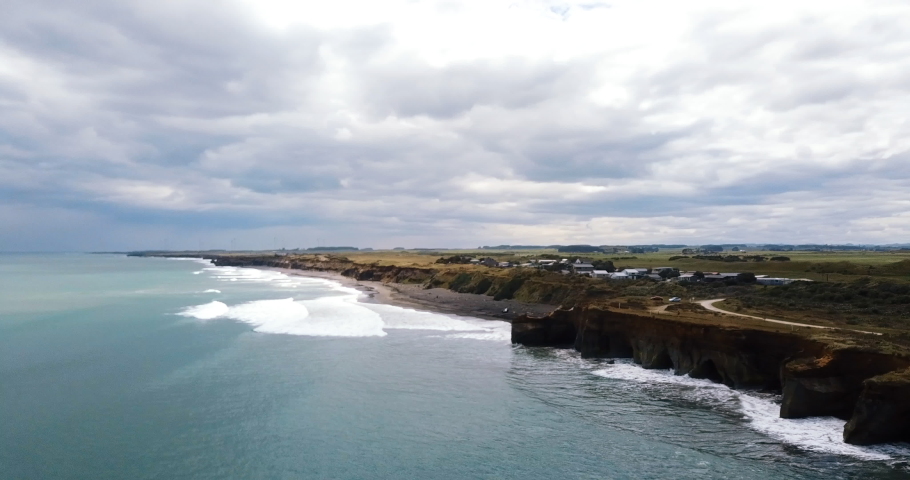 Flight towards Waverley Beach as a storm front approaches from the north