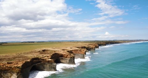 Aerial reveals dramatic jagged rocky outcrops and sinkholes along coastline