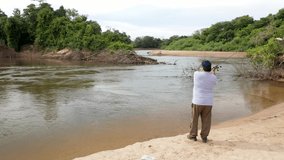 fisherman casting artificial bait in Aquidauana river, Pantanal Sul, Brazil