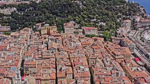 Nice France Aerial v13 birds eye view away from castle hill waterfall toward old city townscape with beautiful mediterranean coast and seafront promenade des anglais - July 2021