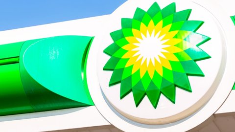 Moscow, Russia - December 7, 2021: BP - British Petroleum petrol station logo over blue sky. British Petroleum is a British multinational oil and gas company