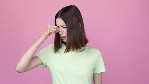 Frustrated lady ignore bad scent close nose isolated pink color background