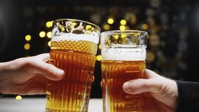 Friends toast beer glasses and drink. Clinking glasses in beer shop. Couple at the pub celebrating weekend. - Powered by Shutterstock - Get 15% off with code: PIKWIZARD15