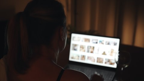 Woman watching porn sites at night.