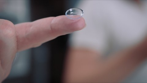 Closeup of Contact lens on man finger, Correction of myopia eyesight concept
