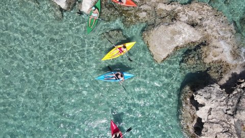 Canoe Kayak in beautiful green sea with crystal clear water - drone shot