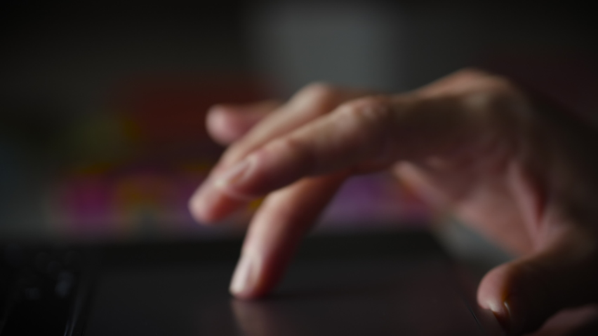 Lateral Dolly Detail Shot of Female Hands Typing and Scrolling on Laptop Track Pad. Shallow Depth of Field. Dark Background. Royalty-Free Stock Footage #1083622714
