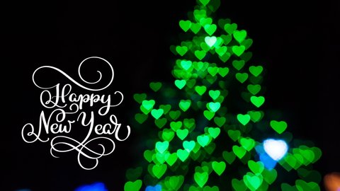 Writing of a white Happy New Year animation calligraphy lettering on a dark with green bokeh background. Christmas 3D For Greeting card. Happy feeling. Animation Merry christmas video.