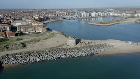 Aerial over the Martello Tower near the entrance to Sovereign Harbour near Eastbourne with the Marina in the background.