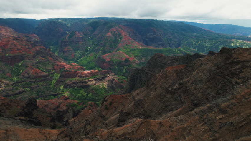 Epic aerial fly over of Waimea Canyon on Kauai in Hawaii. Slow zoom in. Royalty-Free Stock Footage #1083634390