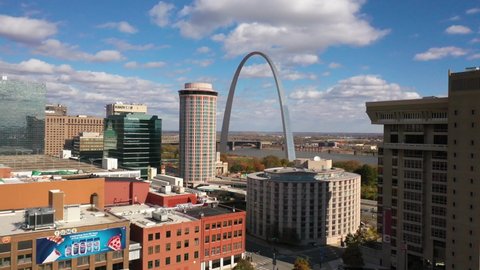 ST. LOUIS MISSOURI - CIRCA 2020s - Good aerial over downtown St. Louis reveals the Gateway Arch and Mississippi River background.