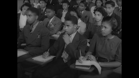 CIRCA 1939 - African-American students take notes during a lecture at Dillard University.