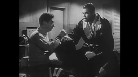 CIRCA 1953 - In this biopic, Joe Louis worries about his future to the man taping his hands.