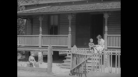CIRCA 1939 - A nurse makes a house call in rural Georgia to give a woman a shot.