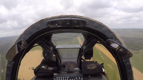 CIRCA 2020s - Cockpit footage of a Fairchild Republic A-10 Thunderbolt II Warthog close support fighter jet flying over rural terrain.