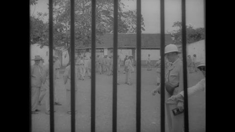 CIRCA 1939 - Prisoners are gathered for a head count on Devil's Island, and doctors work in the infirmary.