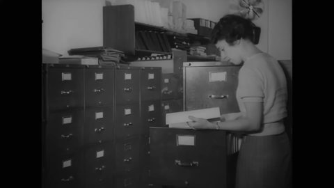 CIRCA 1937 - Women working in Thomas Dewey's office sort through old case files.