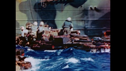 CIRCA 1945 - US Marines ride in troop transport ships and landing crafts headed for Iwo Jima on choppy waters.