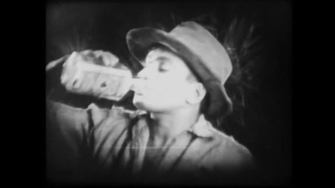 CIRCA 1920 - In this silent film, a man finds his only solace in drinking.