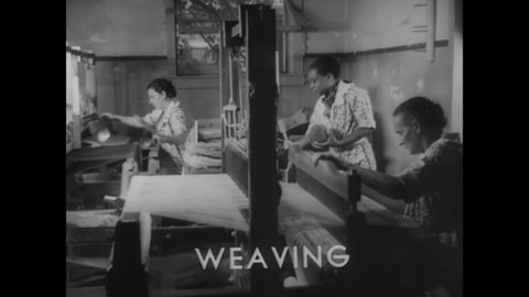 CIRCA 1936 - Black and white women work together as weavers in Missouri, using hand looms and spinning wheels.