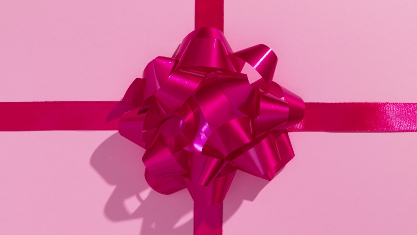 Unwrapping gift for saint Valentine's Day revealing a green screen - Stop Motion Animation - Pink bow on pink wrapping paper Royalty-Free Stock Footage #1083638878
