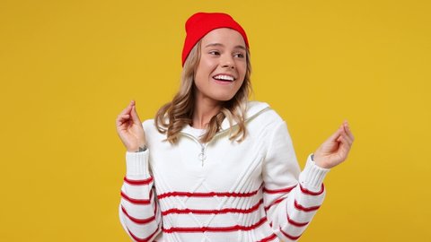 Fun young girl teen student wears striped white shirt hat dance waving rising expressive gesticulating hands fooling around have fun enjoy celebrate isolated on plain yellow background studio portrait