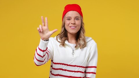 Fun young girl teen student wears striped white shirt hat countdown 1 2 3 one two three go celebrate win scream rejoices doing winner hands gesture isolated on plain yellow background studio portrait