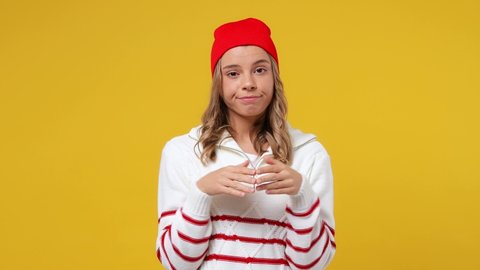 Sarcastic boring dull tedious uninspired sad young girl teen student wears striped white shirt hat looking around applause cheering clapping hands isolated on plain yellow background studio portrait