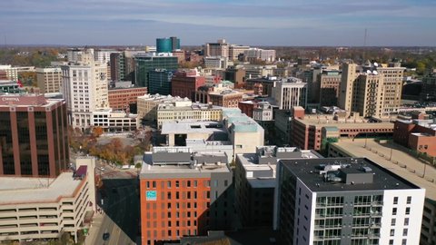 GRAND RAPIDS, MICHIGAN - CIRCA 2020s - Good aerial over Grand Rapids, Michigan apartment tower, downtown and city skyline.