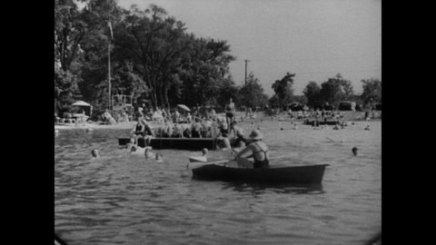 CIRCA 1936 - Swimming pools are enjoyed by black and white communities alike in New Jersey.