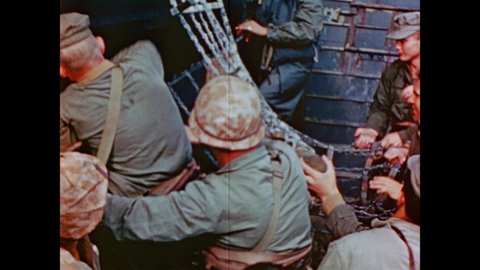 CIRCA 1945 - Netting is lowered from a US Navy troop transport ship to US Marines in a landing craft below.
