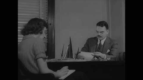 CIRCA 1937 - Thomas Dewey pores over evidence in the Lucky Luciano case.