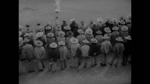 CIRCA 1939 - Guards gather prisoners in the exercise yard on Devil's Island.
