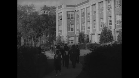 CIRCA 1939 - After leaving class, students walk along campus paths at Tuskegee Institute.