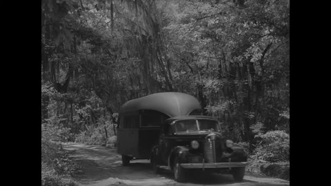 CIRCA 1939 - A mobile health clinic drives through a rural part of Georgia.