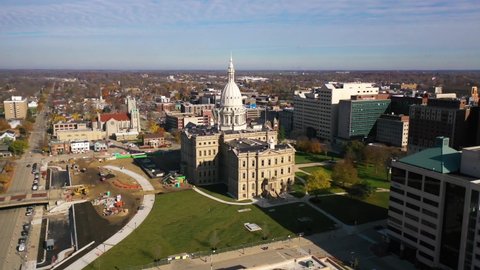 LANSING, MICHIGAN - CIRCA 2020s - Good aerial over Lansing, Michigan, the state capitol building and downtown.