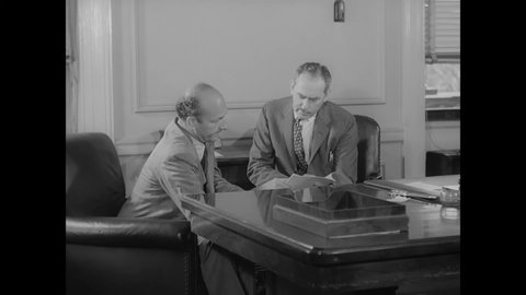 CIRCA 1946 - Under Secretary of State Dean Acheson receives a visit from a representative of the National Committee on Atomic Information.