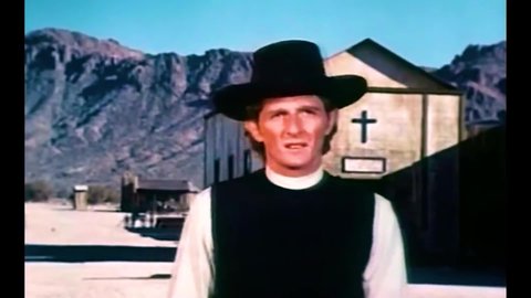 CIRCA 1974 - In this western film, two gunfighters draw when a coin is flipped at a shoot-out.