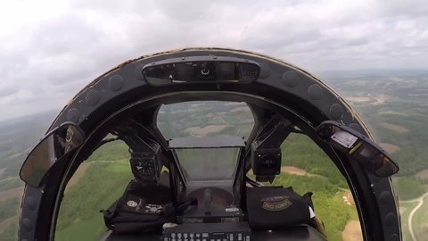 CIRCA 2020s - Cockpit footage of a Fairchild Republic A-10 Thunderbolt II Warthog close support fighter jet flying over rural terrain.