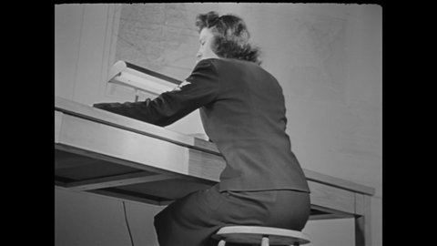 CIRCA 1944 - A US Navy WAVE demonstrates the criss cross exercise ideal for those with desk jobs.