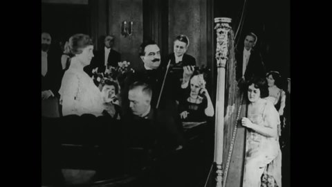 CIRCA 1919 - In this silent film, Anne Sullivan teaches Helen Keller to appreciate music by feeling the instruments' vibrations.