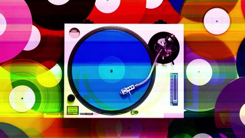 Overhead spinning shot of DJ turntables with different coloured records on the floor 