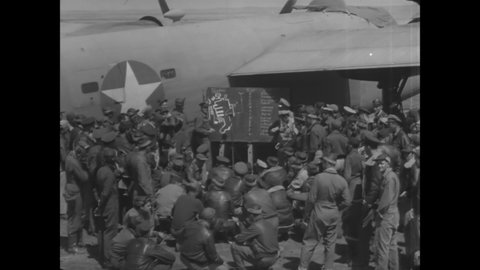 CIRCA 1940s - US Army Air Force airmen are briefed on a mission on a runway.
