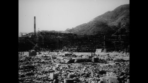 CIRCA 1945 - People walk through the demolished remnants of a Mitsubishi Steel and Arms Works plant in Nagasaki after it was hit by the atomic bomb.